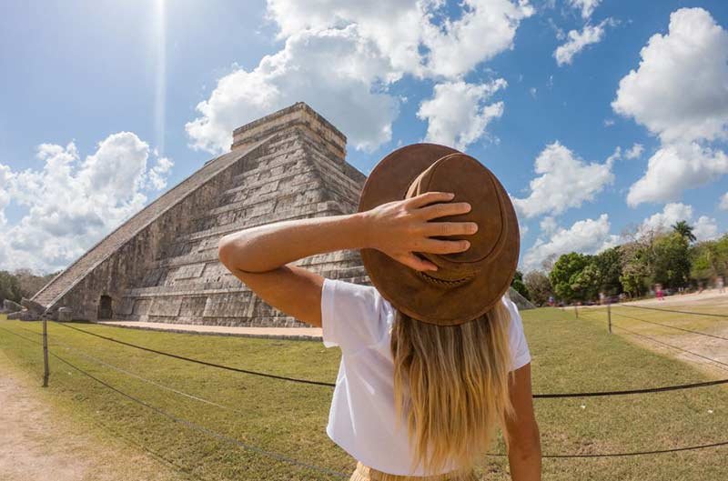 woman gazing at Mayan pyramid